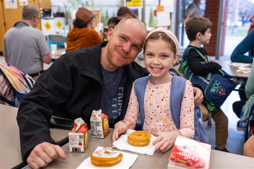 Students and their families enjoy donuts